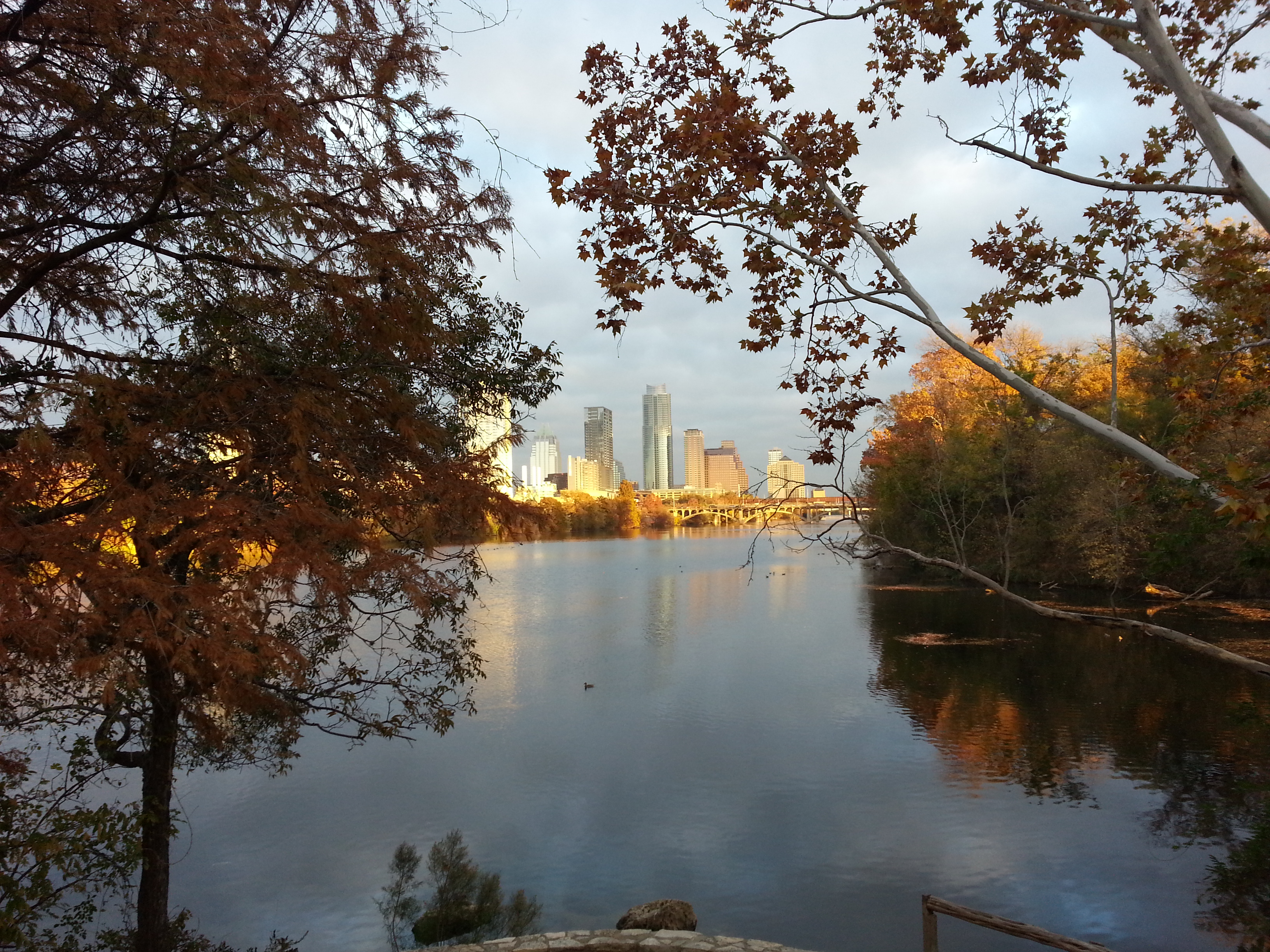 The Austin skyline at golden hour seen from Lady Bird Lake near Auditorium Shores